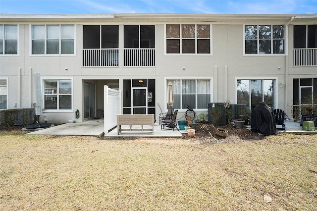 back of house featuring a yard and a patio