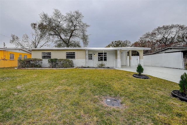 single story home featuring a front yard and a carport