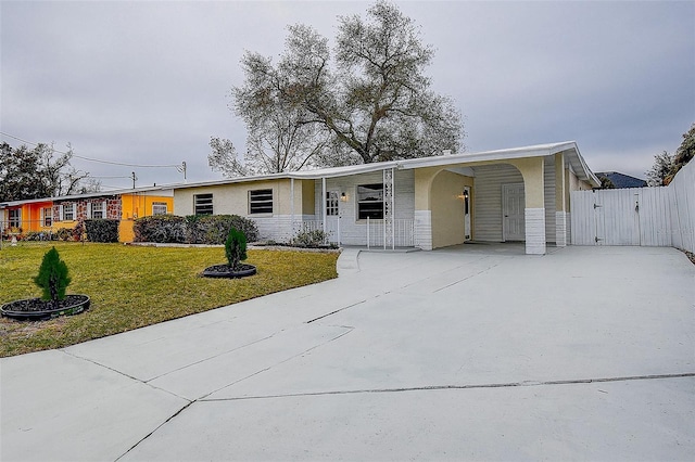 view of front facade with a front lawn and a carport