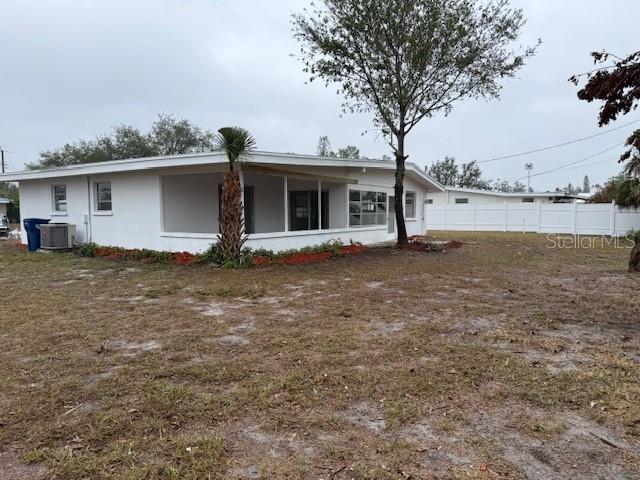 rear view of house with central AC unit