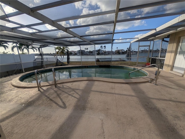 view of swimming pool featuring a patio area, glass enclosure, and a water view