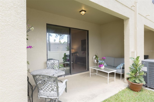 entrance to property featuring a patio area and cooling unit