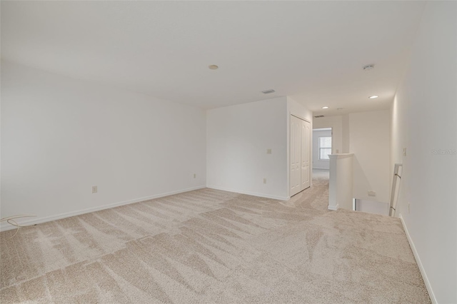 unfurnished room with light carpet