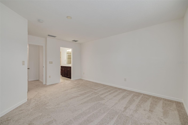 unfurnished room with light colored carpet