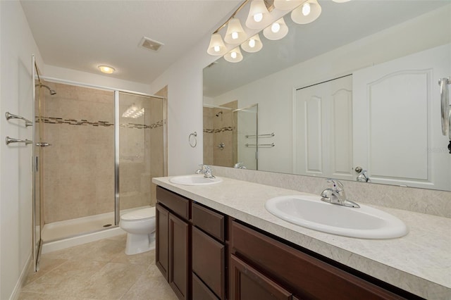 bathroom with vanity, toilet, walk in shower, and tile patterned flooring