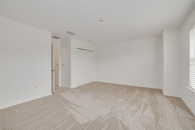 unfurnished room with light colored carpet