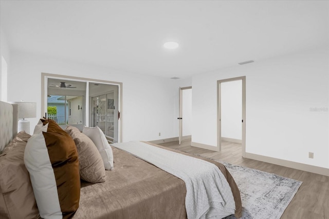 bedroom with access to exterior and light wood-type flooring