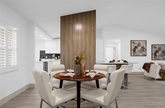 dining area with sink and light hardwood / wood-style floors