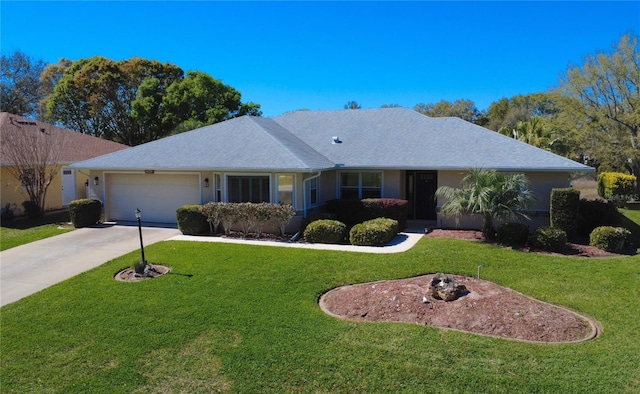 single story home with a front lawn, concrete driveway, an attached garage, and stucco siding