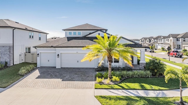 view of front of house featuring a garage and a front yard