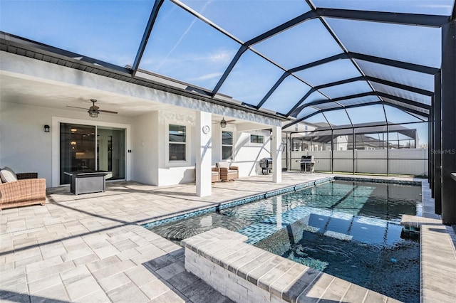 view of swimming pool featuring a lanai, a patio area, and ceiling fan