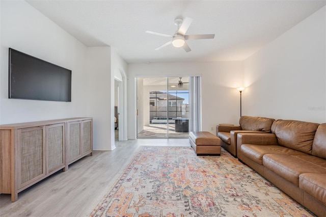 living room featuring ceiling fan and light hardwood / wood-style flooring