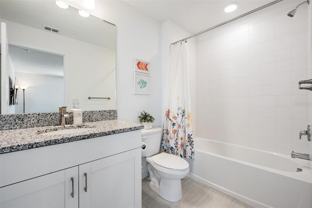 full bathroom with shower / bath combination with curtain, vanity, and toilet