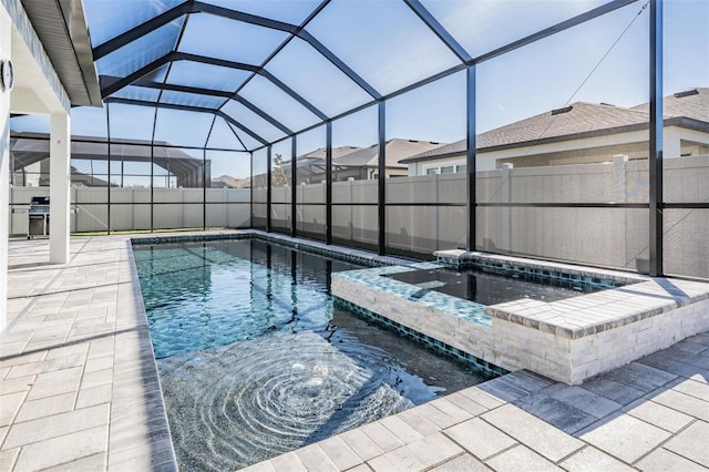 view of pool featuring a grill, a lanai, a patio, and an in ground hot tub