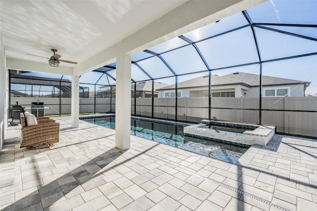 view of swimming pool with area for grilling, a lanai, a patio, and an in ground hot tub