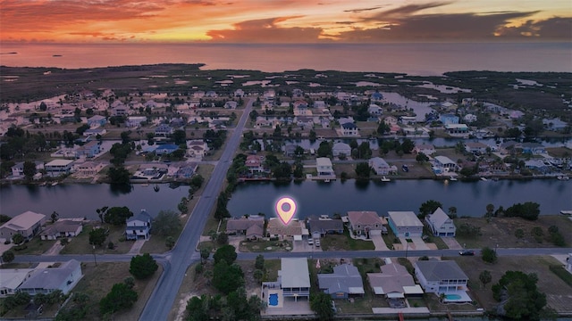 aerial view at dusk with a water view