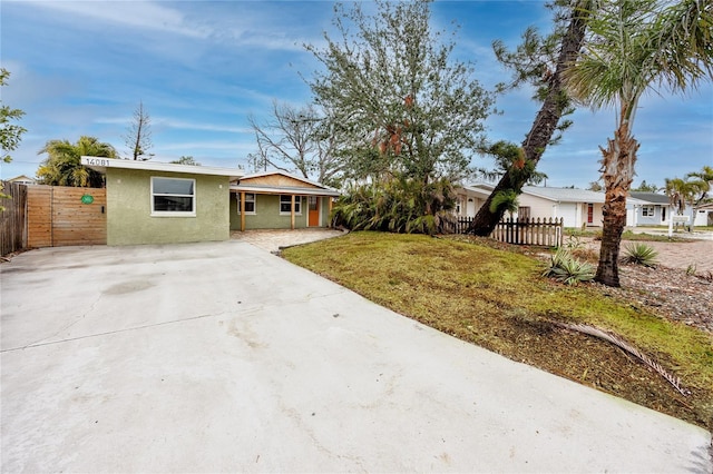 ranch-style home with a front lawn