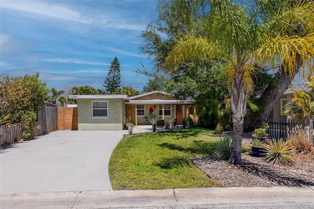 ranch-style house with a front yard and covered porch