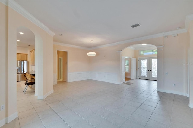 unfurnished room featuring arched walkways, french doors, crown molding, light tile patterned floors, and visible vents