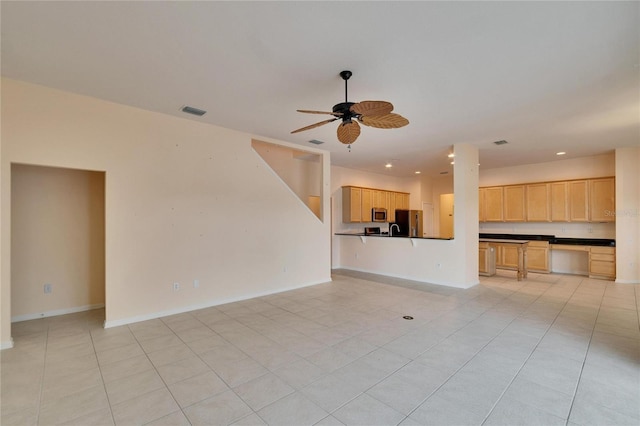 unfurnished living room featuring light tile patterned floors, ceiling fan, visible vents, and baseboards