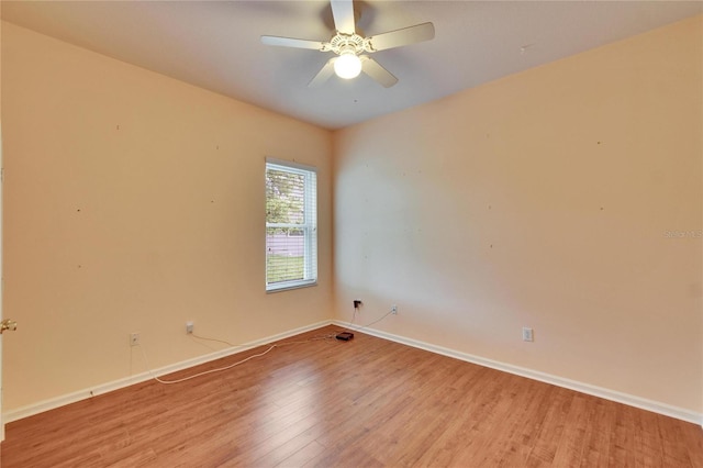 empty room featuring baseboards, ceiling fan, and light wood finished floors