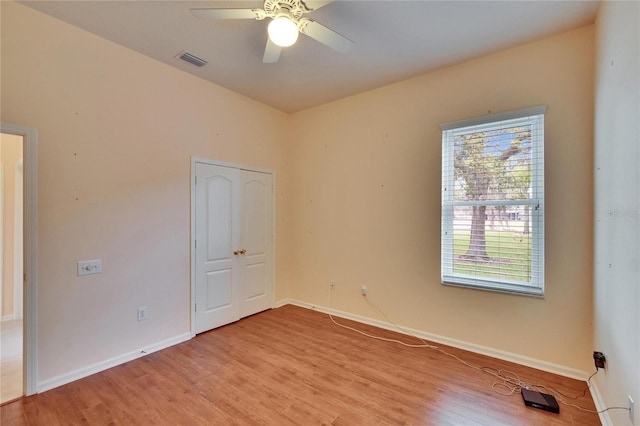 unfurnished bedroom with baseboards, ceiling fan, visible vents, and light wood-style floors