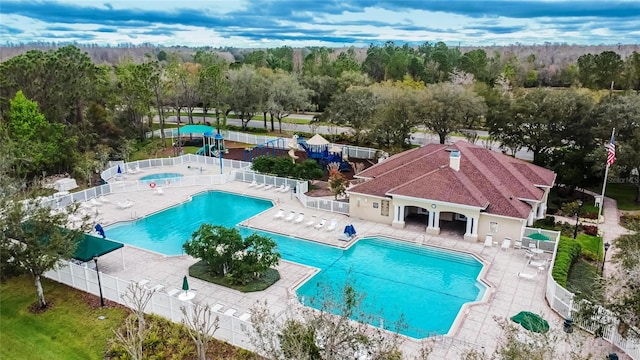 community pool featuring a patio and fence