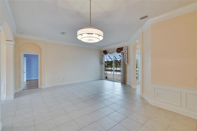 unfurnished room with arched walkways, light tile patterned floors, visible vents, and crown molding