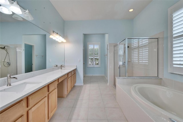 full bath with a bath, tile patterned flooring, a shower stall, and a sink