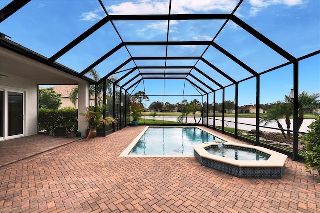 view of swimming pool with a lanai, a pool with connected hot tub, and a patio