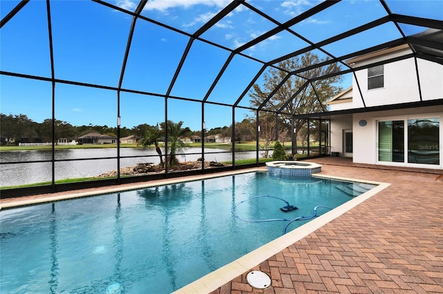 view of pool featuring a water view, glass enclosure, a pool with connected hot tub, and a patio