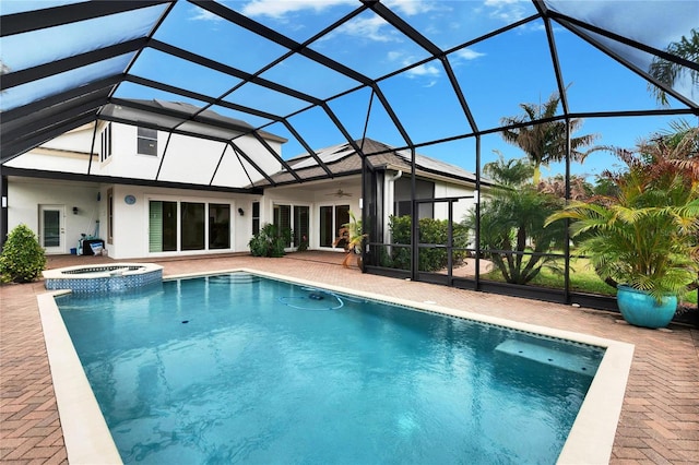 view of pool featuring a ceiling fan, a lanai, a patio area, and a pool with connected hot tub