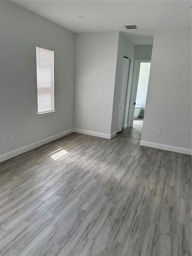 spare room with light hardwood / wood-style floors