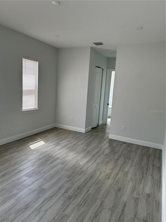 empty room with light hardwood / wood-style floors