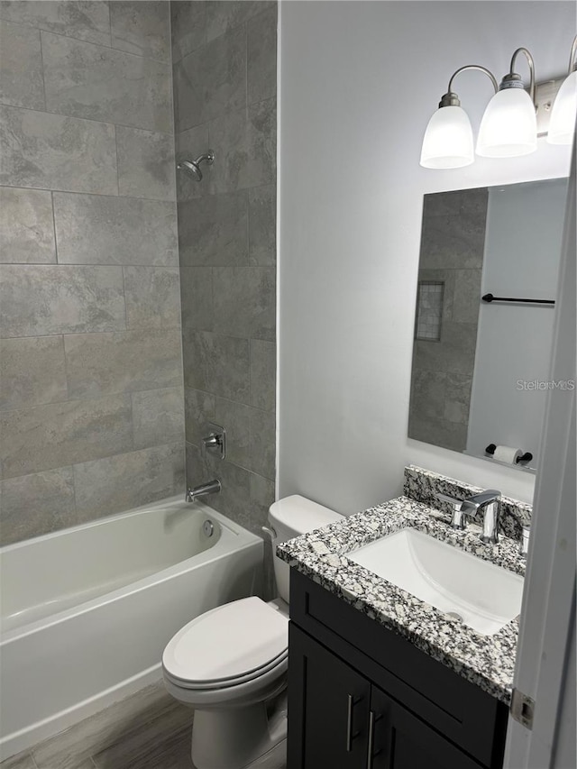 full bathroom with hardwood / wood-style flooring, toilet, vanity, and tiled shower / bath combo