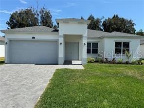 view of front of house featuring a garage and a front lawn