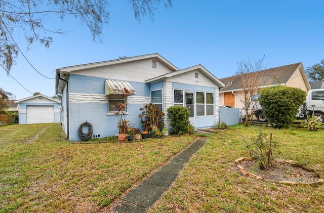 view of front of house with a garage and a front lawn