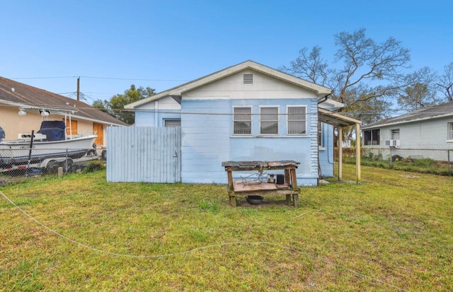 back of property featuring a lawn