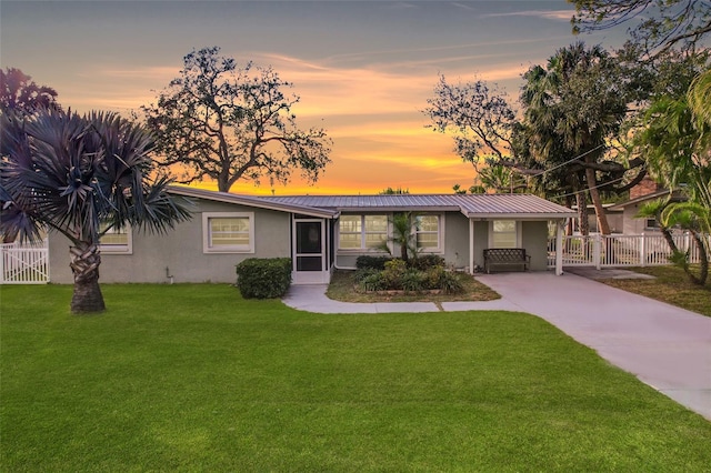 ranch-style house featuring a lawn