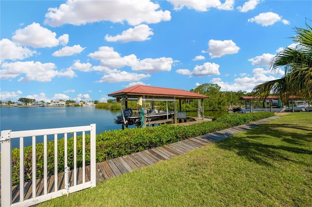 dock area featuring boat lift, a water view, and a yard