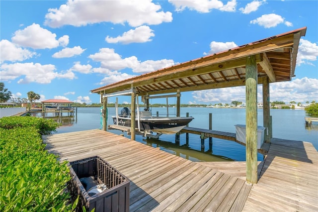 dock area featuring boat lift and a water view