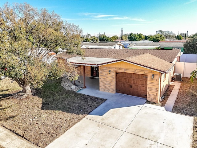 ranch-style home with a carport and cooling unit