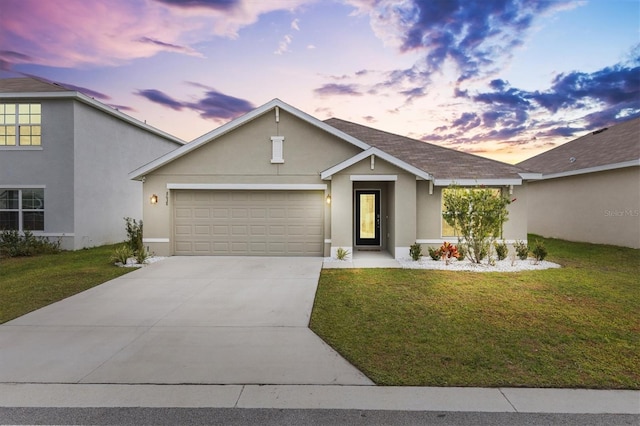 view of front facade with a garage and a lawn