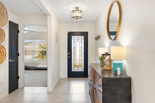 carpeted entrance foyer with a chandelier