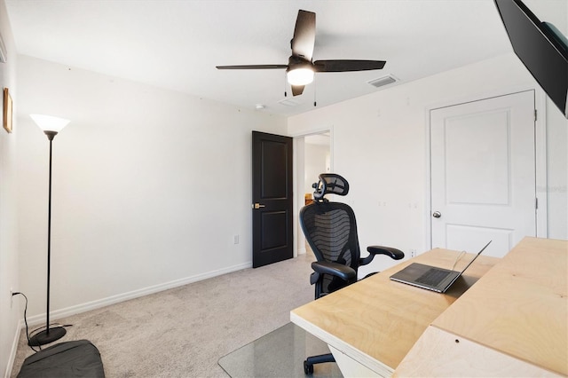 home office with ceiling fan and light carpet