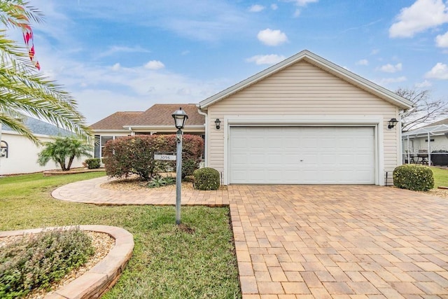 ranch-style home with a garage and a front lawn