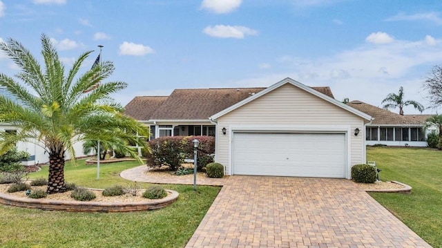 ranch-style house with a garage and a front lawn