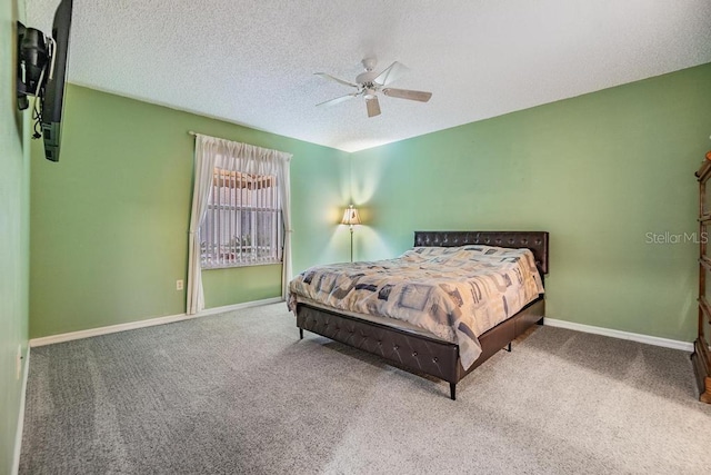 carpeted bedroom with ceiling fan and a textured ceiling