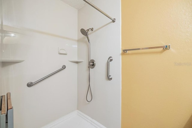 bathroom featuring tile patterned floors, a textured ceiling, and a shower