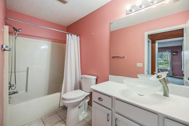 full bathroom featuring tile patterned flooring, vanity, shower / tub combo, toilet, and a textured ceiling